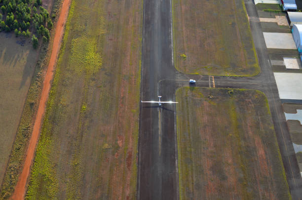 Private hangar with runway airplane, aerial view