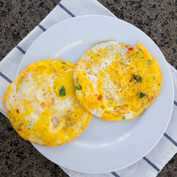 istock Omelette with vegetables on white plate 1130289805