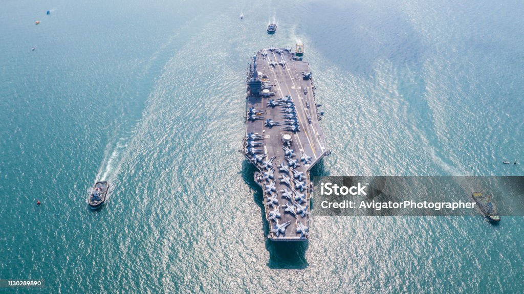 Navy Nuclear Aircraft carrier, Military navy ship carrier full loading fighter jet aircraft, Aerial view. Navy Stock Photo