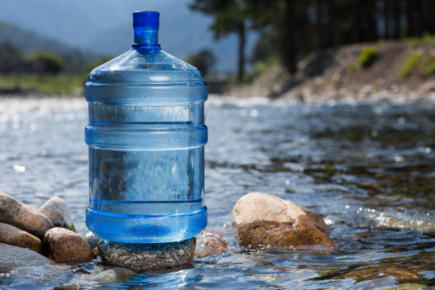 Water Big Bottle On Mountains And Rivers Background Stock Photo - Download  Image Now - iStock