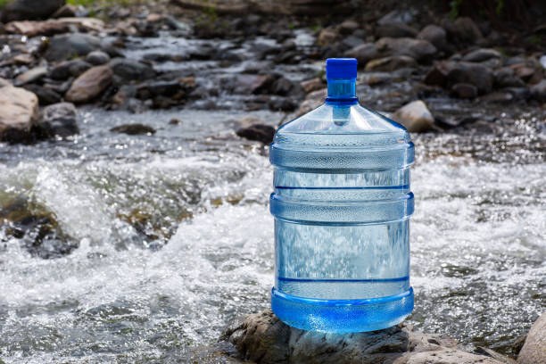 istock Water big bottle on mountains and rivers background 1130291083