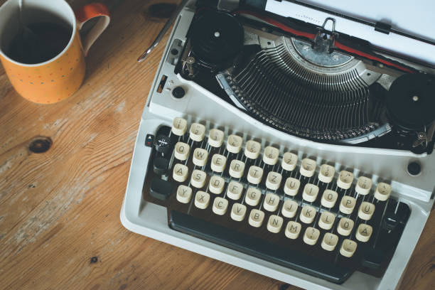 istock Old fashioned vintage typewriter on wooden desk 1130292023