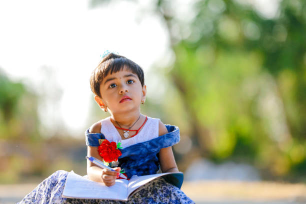 istock Indian Little Girl child writing on note book , studying 1130292399