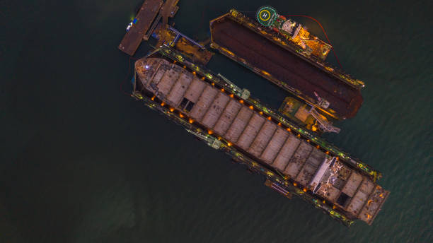 istock Ship in shipyard aerial view, ship in floating dry dock under repair by sandblasting and painting in shipyard. 1130294363