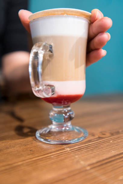 A frothy, layered cup of cappuccino with cinnamon sprinkled on top