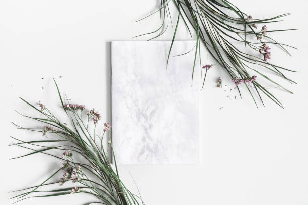 istock Flowers composition. Notepad, dried leaves and flowers on pastel gray background. Flat lay, top view, copy space 1130299231