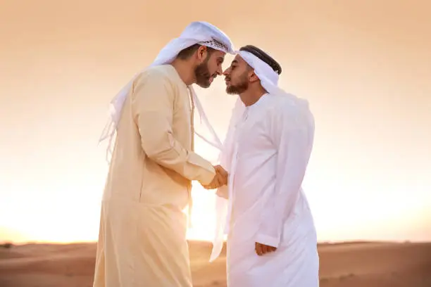 Photo of Arab men greetings in the desert