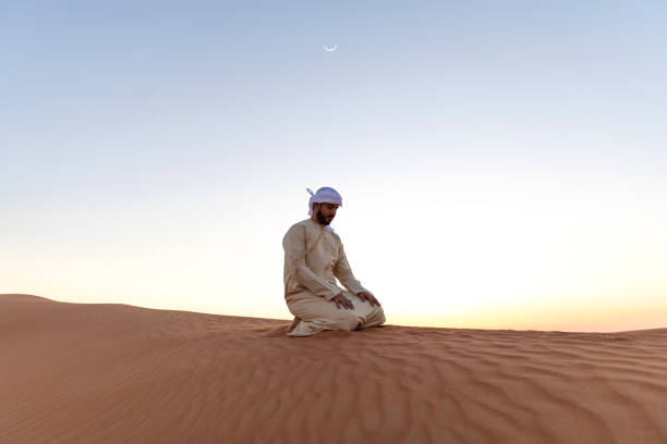 istock Arab man praying in the desert 1130300546
