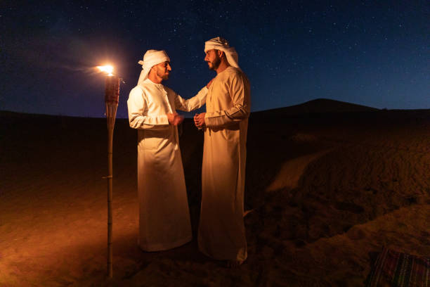 istock Arabs in traditional clothes at night in the desert 1130301461