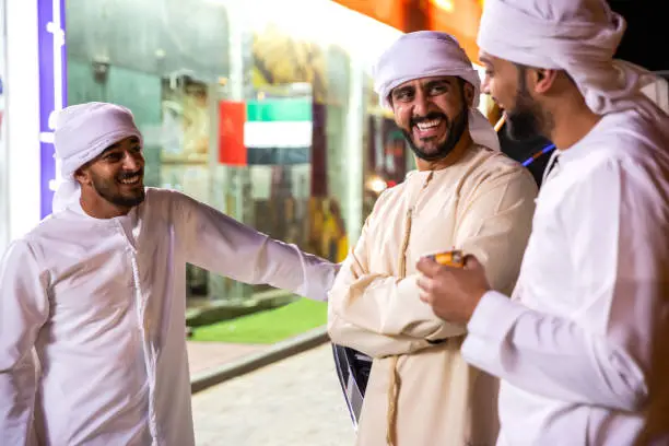 Photo of Arab friends enjoy a night spent together in Dubai