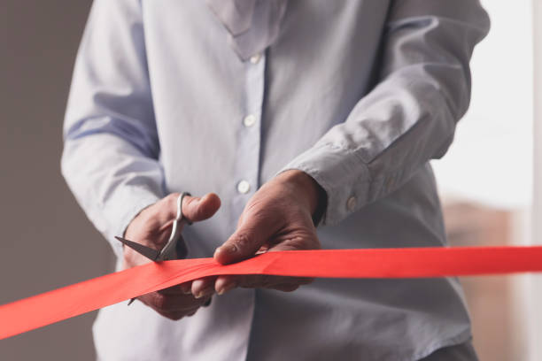 istock Female hands cutting red ribbon 1130302987