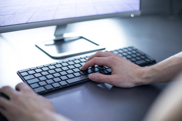 istock Workplace of a freelancer with computer, keyboard and typing hands 1130303606