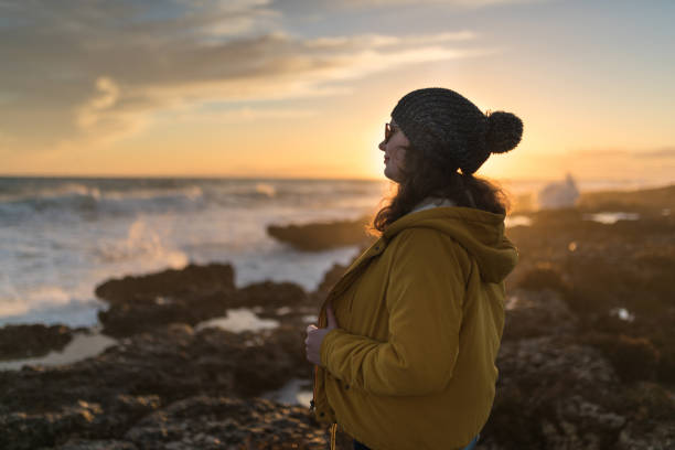 istock woman on the sea at sunset 1130304854