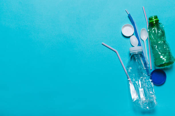 istock Plastic bottles, tubes, spoons, caps on a blue background. 1130305004