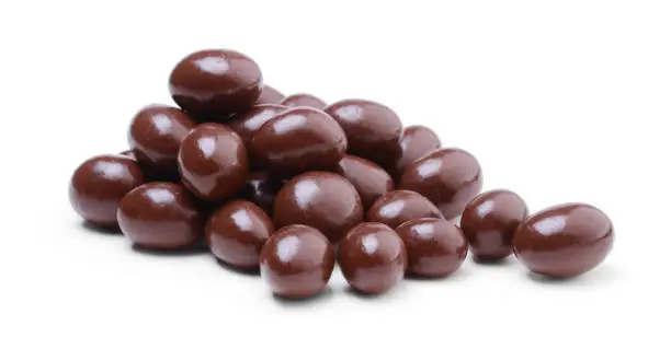 Photo of Peanuts covered in chocolate isolated on white