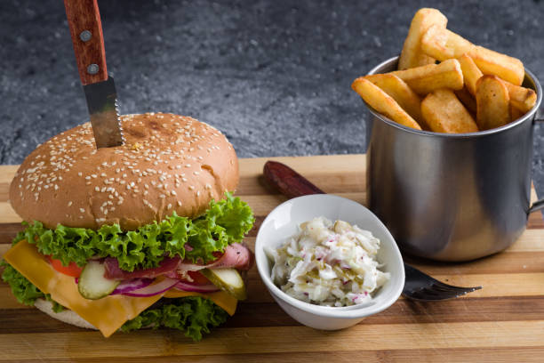 tasty rustic hamburger with fries on wooden table stock photo
