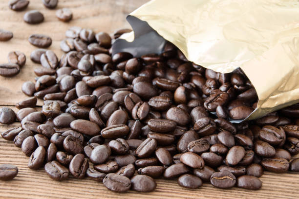 istock Coffee beans and wooden background close up 1130307256