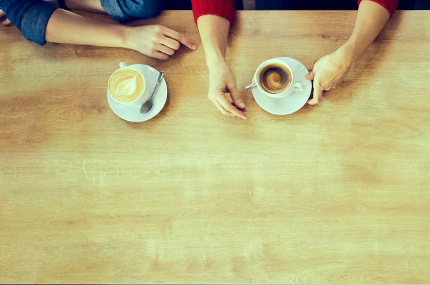 istock Hands of girlfriends with cups of coffee 1130308022