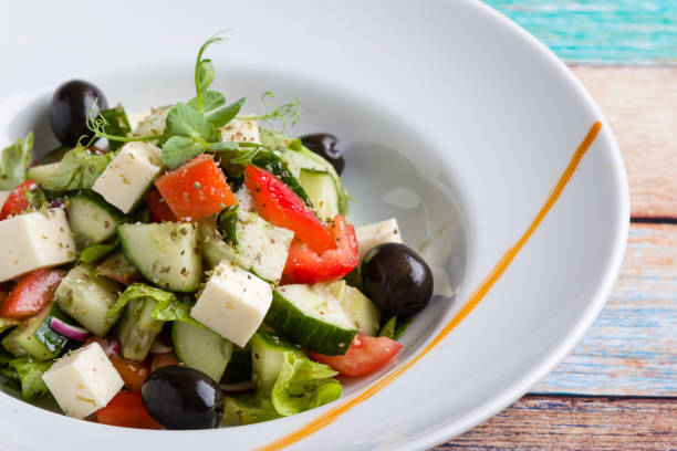 istock fresh tasty greek salad appetizer on white plate 1130308595