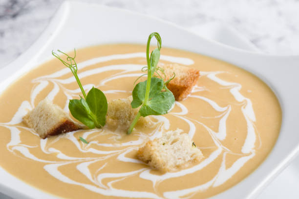istock fresh vegetable cream soup with bread crums in white plate 1130308660