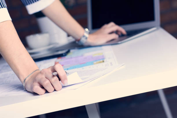 istock Real estate creative studio office. Architect woman working on architectural project for interior design. Woman's hands over the table with the drawing. 1130309011