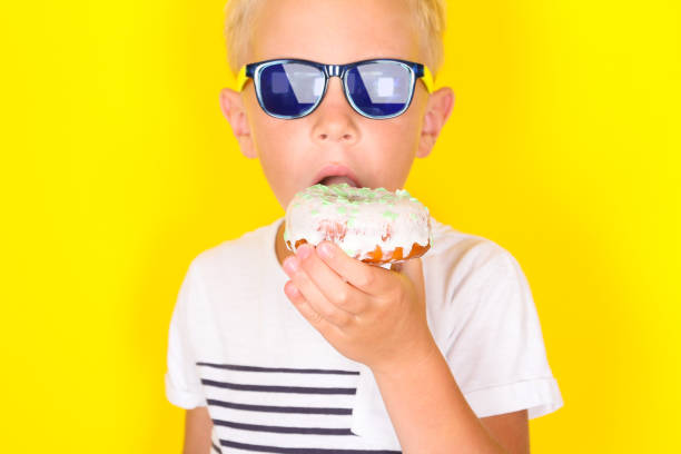 istock Cute cool blond boy wearing sunglasses looking at camera 1130309395