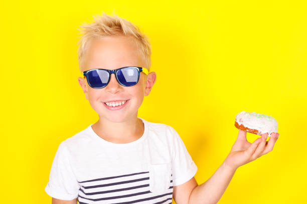 istock Cute cool blond boy wearing sunglasses looking at camera 1130309410