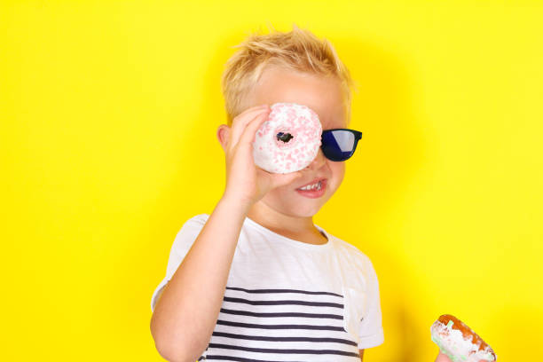 istock Cute cool blond boy wearing sunglasses looking at camera 1130309417