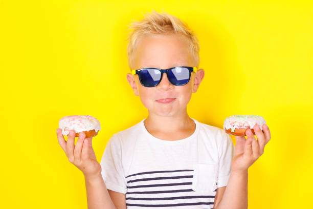 istock Cute cool blond boy wearing sunglasses looking at camera 1130309428