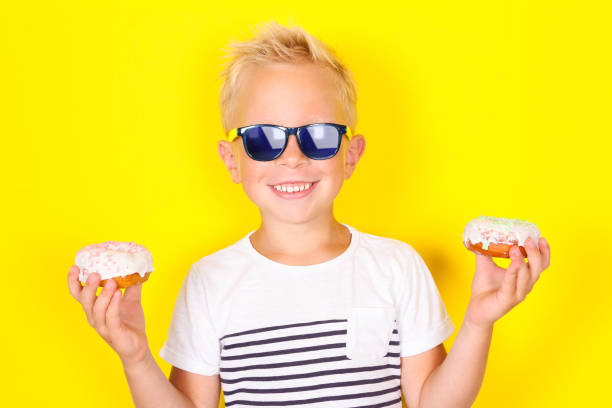 istock Cute cool blond boy wearing sunglasses looking at camera 1130309429