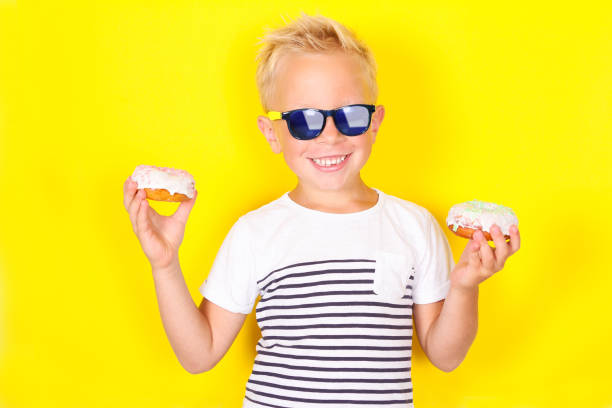istock Cute cool blond boy wearing sunglasses looking at camera 1130309441