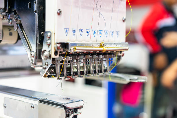 istock Needle and thread of modern and automatic high technology sewing or embroidery machine for textile - clothing apparel making manufacturing process in industrial 1130310484