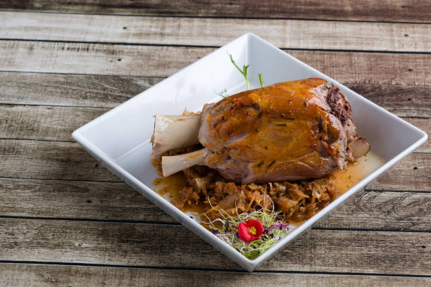 istock bavarian pork knuckle with cabbage on white plate 1130310575