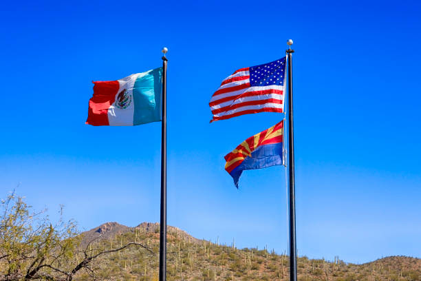 istock Mexican, American and Arizona state Flags at the Border between the two countries 1130310880