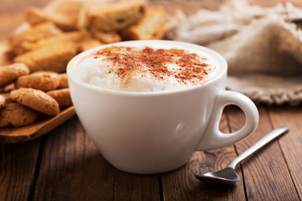 Cup of cappuccino coffee Cup of cappuccino coffee on wooden table cappuccino stock pictures, royalty-free photos & images