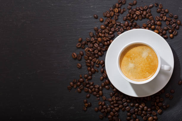 istock cup of coffee and coffee beans on dark background 1130315139