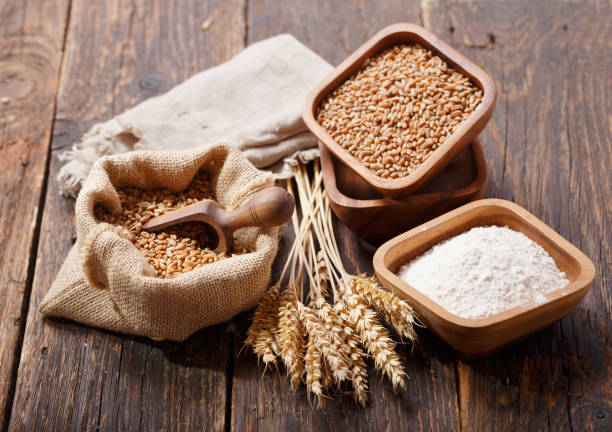 istock grains, flour and wheat ears on a wooden table 1130315145