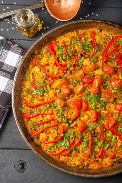 istock Fresh paella in pan on wooden table 1130316788