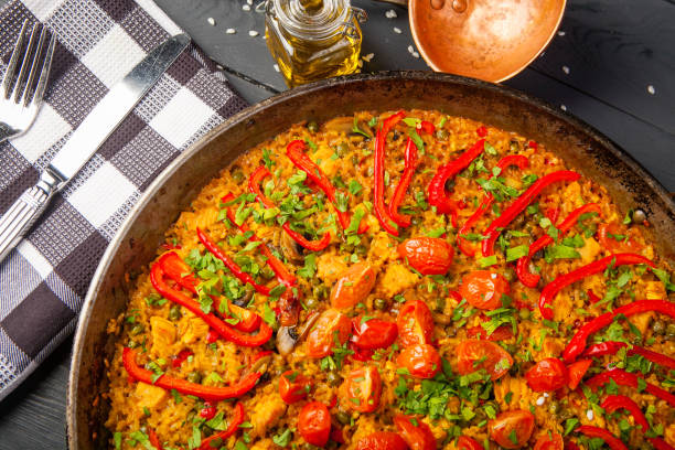 istock Fresh paella in pan on wooden table 1130316792