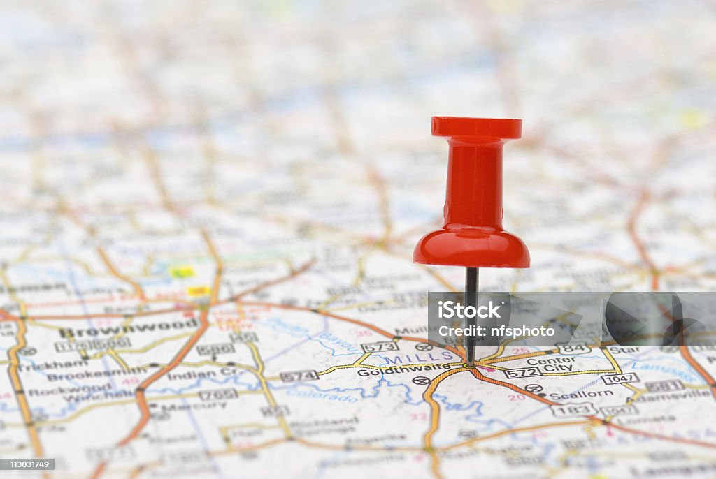 Pushpin marking location on map Red pushpin marking a location on a road map, selective focus Map Stock Photo