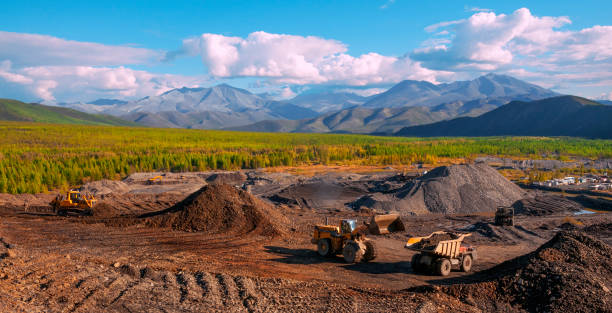 istock Excavation, loading of stone soil into mining dump trucks in mountainous areas (open-pit gold mining in Eastern Siberia) 1130319467