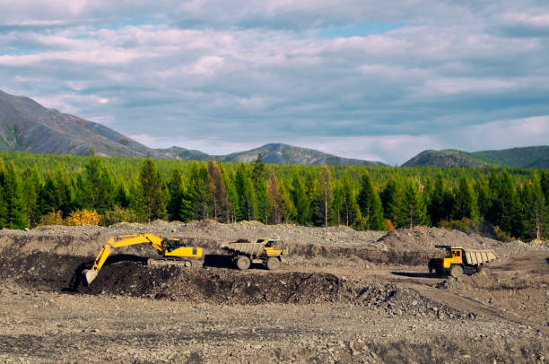 istock Excavation, loading of stone soil into mining dump trucks in mountainous areas (open-pit gold mining in Eastern Siberia) 1130319471