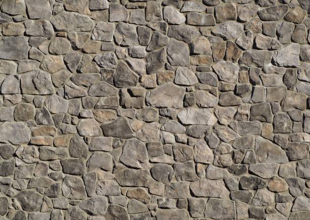istock Massive exterior wall cladding made of gray natural stones with different sizes and shapes 1130319712