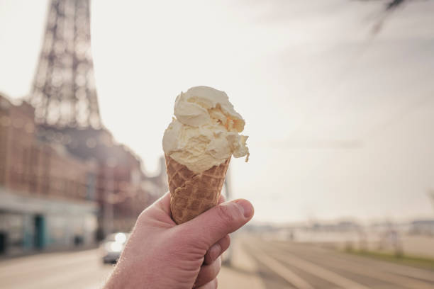 istock Hand holding an Ice cream cone at Blackpool seafront. 1130321349