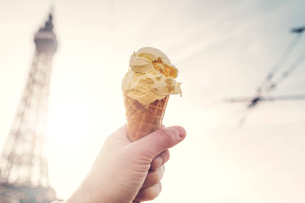 istock Hand holding an Ice cream cone , defocused Blackpool tower in the background. 1130321353
