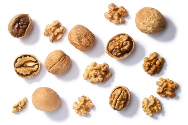 Walnuts (Juglans regia seeds), whole, shelled, halves and partially cracked, top view