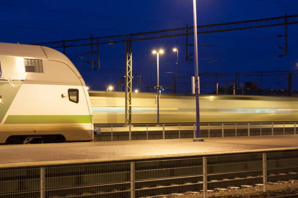 istock Train in motion on the station at night, long exposure photo. 1130321696