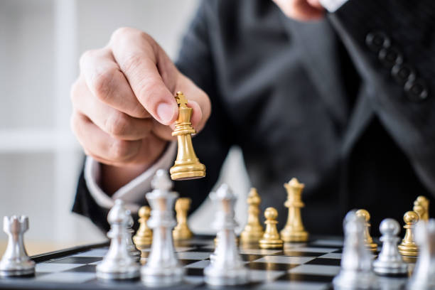 istock Hands of confident businessman playing chess game to development analysis new strategy plan, leader and teamwork concept for win and success 1130323393