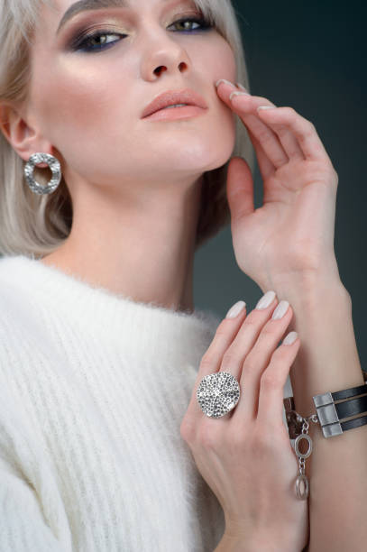 istock Young lady with luxury accessories on Gray background 1130324487