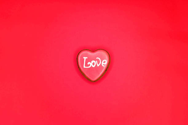 istock Two cinnamon heart candies coated with sugar sitting on white background 1130324553